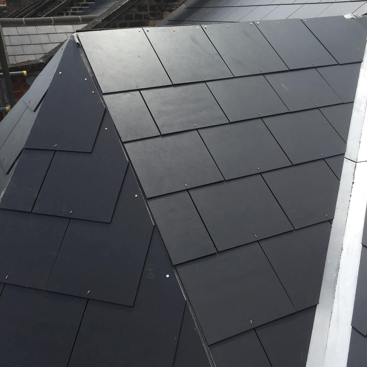 New roofing tiles installed on a residential property with clear edge alignment