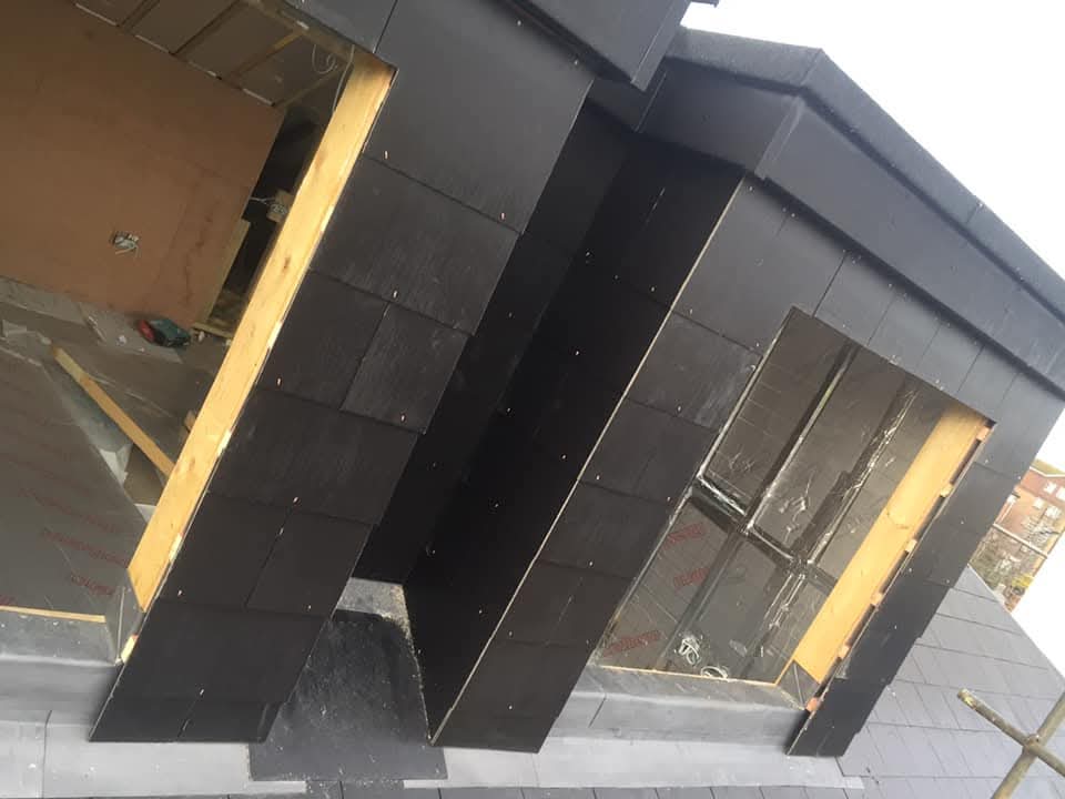 Dormer and roofline finish completed with clean edge and slate transitions