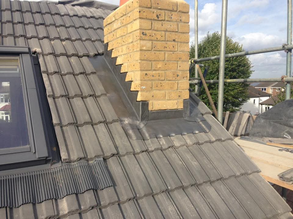Close view of finished flashing and ridge detail on a completed roof